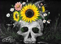 a skull with sunflowers on it's head